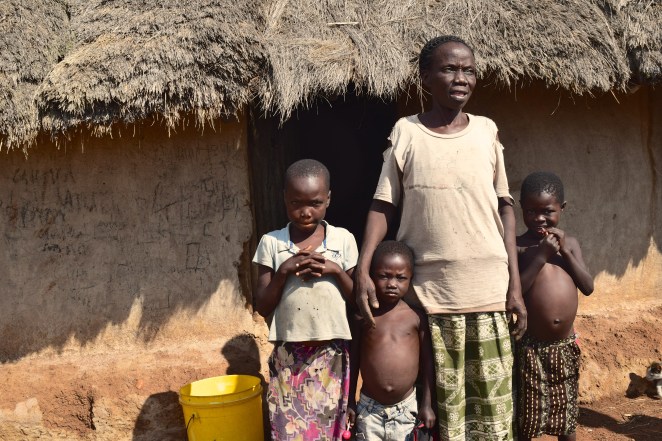 A widowed grandmother raising 3 kids in this thatch-roof hut